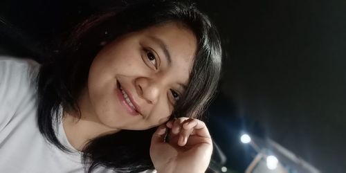 Close-up portrait of a smiling young woman