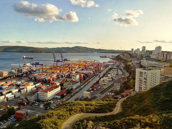 High angle view of cityscape by sea against sky