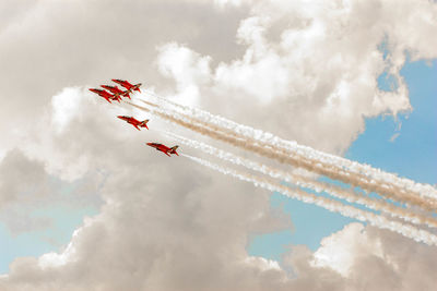 Low angle view of airshow against sky