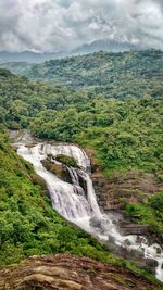 Scenic view of waterfall against sky