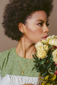 Portrait of young woman holding pineapple