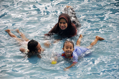 Portrait of smiling girl swimming in pool