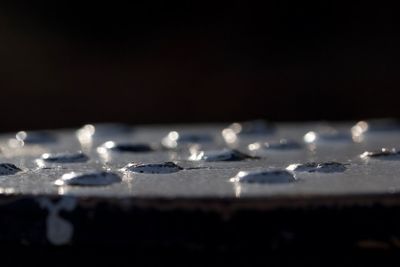 Surface level of white table against black background