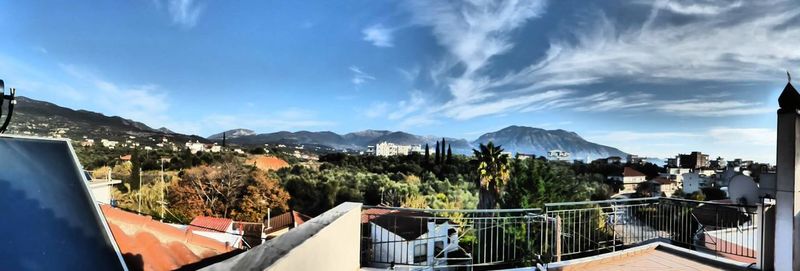 Houses in town against cloudy sky