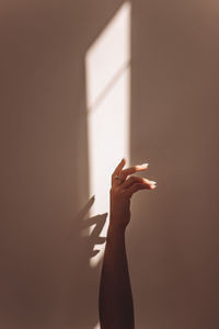 Close-up of hand against wall