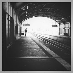 Full length of woman walking on footbridge