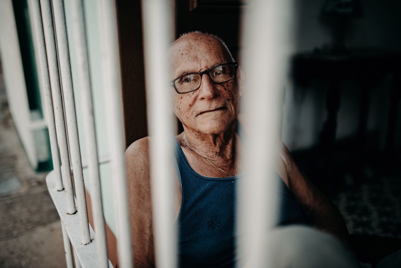 portrait, real people, one person, eyeglasses, glasses, looking at camera, adult, front view, men, males, headshot, lifestyles, mature adult, indoors, mature men, casual clothing, selective focus, leisure activity