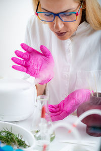 Aroma diffuser in a lab, olfactory science technician smelling the fragrance.