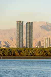 Buildings in city against clear sky