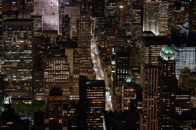 Aerial view of illuminated buildings in city at night