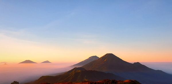 Scenic view of mountains against sky during sunset