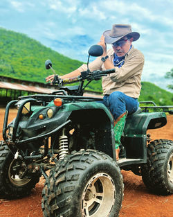 Side view of man riding motorcycle on field