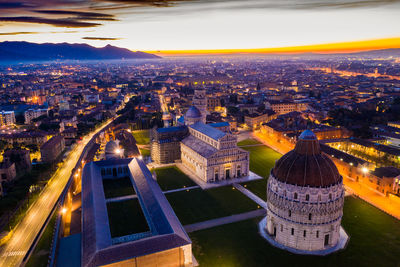 High angle view of buildings in city at sunset