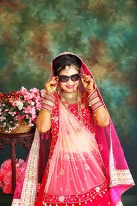 Portrait of woman wearing sunglasses standing outdoors