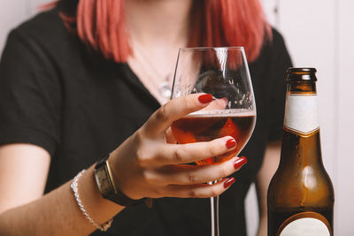 Midsection of woman drinking glass