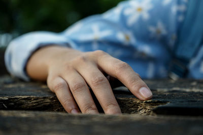 Close-up of hands working on table