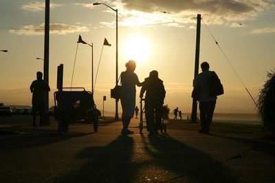 People on beach at sunset