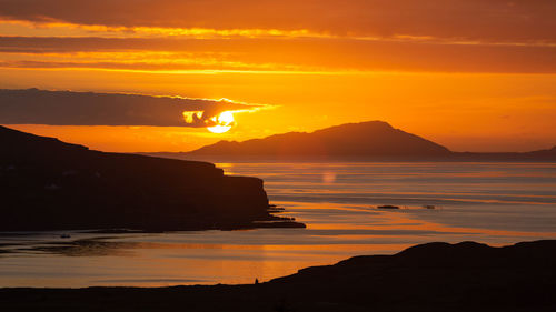 Scenic view of sea against orange sky