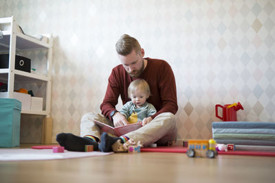 Boy playing with toy blocks at home