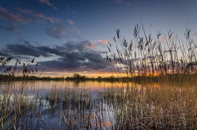 Scenic view of lake against cloudy sky