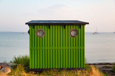 Lifeguard hut on beach against sky