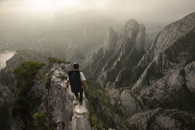 One man walking on a narrow edge on a high exposed area in la huasteca