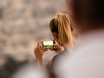Rear view of woman photographing