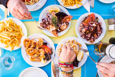 Directly above shot of people eating food at table