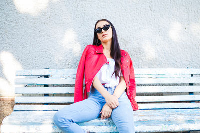 Portrait of beautiful young woman sitting outdoors