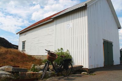 Exterior of house by building against sky