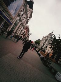 Woman walking on street in city