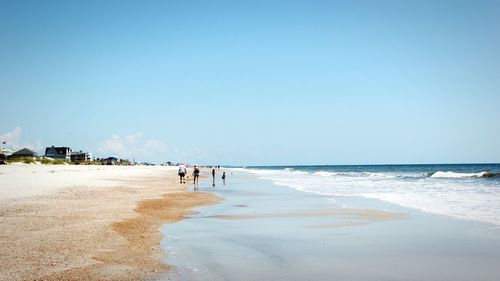 Scenic view of beach against blue sky