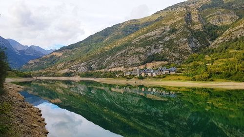 Scenic view of lake and mountains against sky