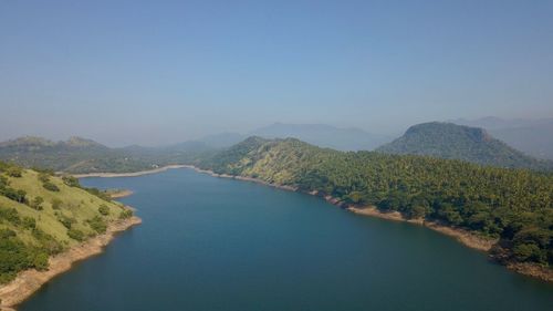 Scenic view of lake and mountains against clear sky