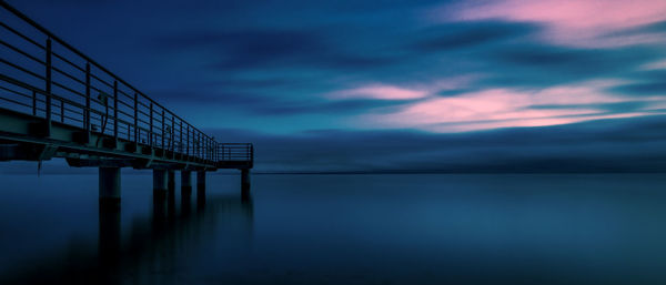 Pier over sea against sky