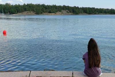 Rear view of woman looking at lake