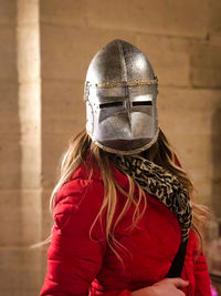 Portrait of woman with armor on head standing 
