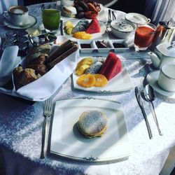 High angle view of fruits and pancakes in plate on table