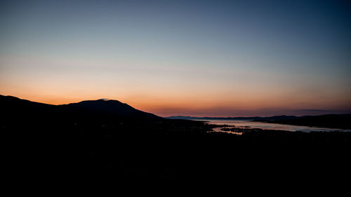 Scenic view of silhouette mountains against sky during sunset