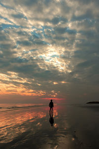 A boy walking on the beach