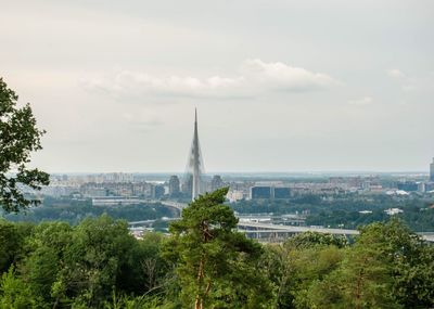 View of buildings in city against cloudy sky