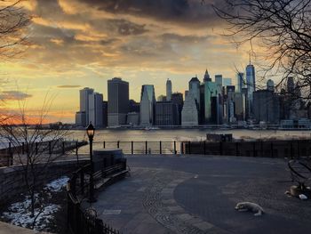 View of city at waterfront during sunset