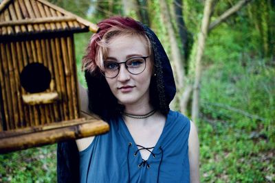 Portrait of woman with birdhouse