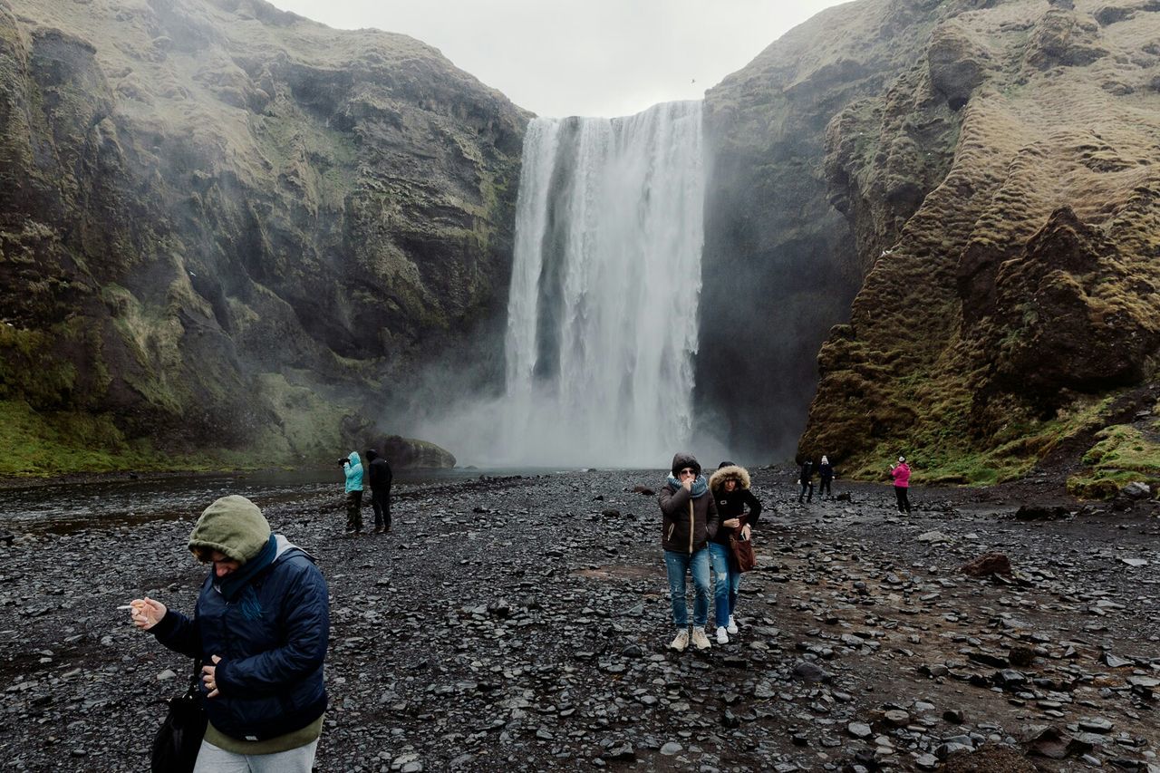 water, waterfall, motion, leisure activity, lifestyles, rock - object, men, flowing water, mountain, beauty in nature, scenics, long exposure, nature, flowing, rock formation, rear view, tourism, vacations, travel