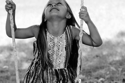 Portrait of smiling girl on swing