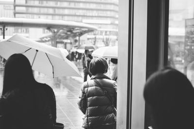 Rear view of people traveling in city