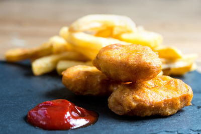 Close-up of fresh nuggets with ketchup served on table