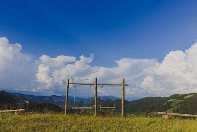 Windmills on field against sky