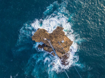 High angle view of rocks in sea