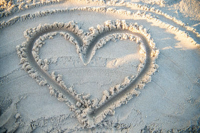 Close-up of heart shape on sand